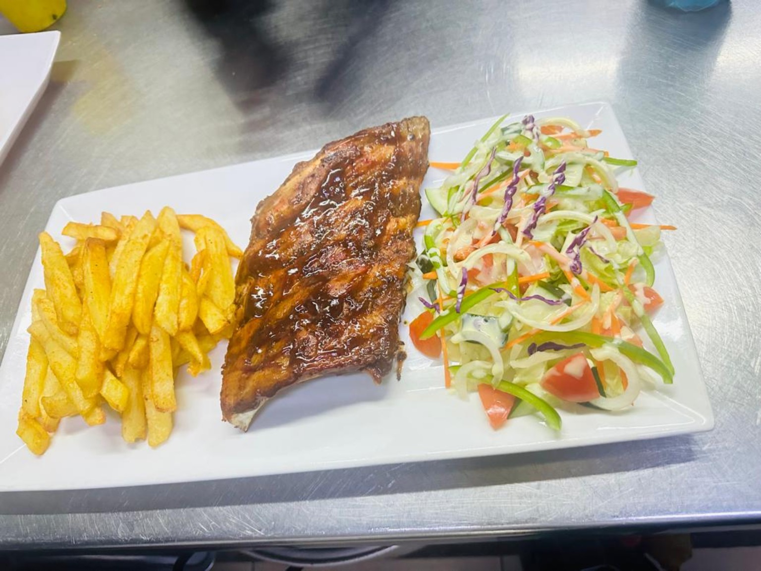 Grilled fish menu selection with chips and salad at The Standard Hotel