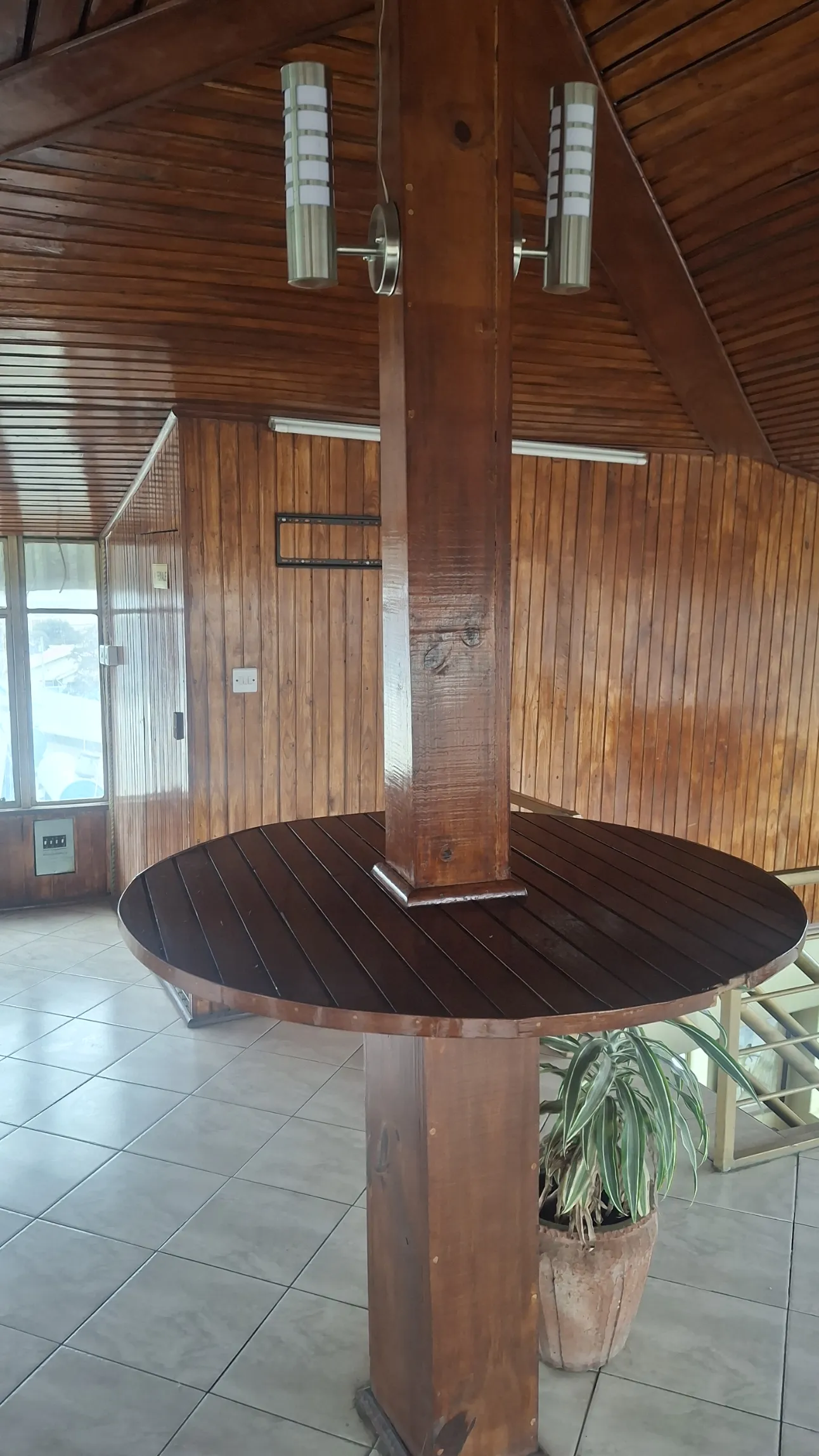 Rooftop round table under the wood-beamed ceiling